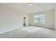 Bedroom with gray carpet and a window overlooking the street at 604 Emerald Bay Cir, Raleigh, NC 27610