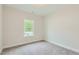 Well-lit bedroom with grey carpet and a window offering a pleasant view at 604 Emerald Bay Cir, Raleigh, NC 27610