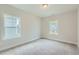 Bright bedroom with neutral walls and carpet, featuring two large windows at 604 Emerald Bay Cir, Raleigh, NC 27610