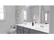 Bathroom with double vanity, gray cabinets, and a shower at 605 Emerald Bay Cir, Raleigh, NC 27610