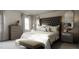 Main bedroom with tufted headboard and bench at 605 Emerald Bay Cir, Raleigh, NC 27610