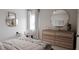 Bedroom with round mirror and wood dresser at 605 Emerald Bay Cir, Raleigh, NC 27610