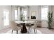 Modern dining room with round table and four beige chairs at 605 Emerald Bay Cir, Raleigh, NC 27610