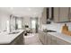 Modern kitchen with gray cabinets, white backsplash, and island at 605 Emerald Bay Cir, Raleigh, NC 27610