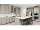 Modern kitchen with gray cabinets, white backsplash, and island with seating at 605 Emerald Bay Cir, Raleigh, NC 27610