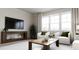Living room with white sofa, two armchairs, and coffee table at 605 Emerald Bay Cir, Raleigh, NC 27610