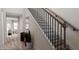 Elegant staircase with black spindles and wood handrail at 605 Emerald Bay Cir, Raleigh, NC 27610