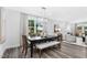 Modern dining room with hardwood floors and large windows at 609 Emerald Bay Cir, Raleigh, NC 27610