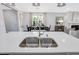 Modern kitchen island with double sink and stainless steel faucet at 609 Emerald Bay Cir, Raleigh, NC 27610