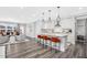 Open concept kitchen with white cabinets, island, and stainless steel appliances at 609 Emerald Bay Cir, Raleigh, NC 27610
