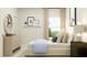 Cozy bedroom with a dresser, a bed, and a window offering natural light at 612 Emerald Bay Cir, Raleigh, NC 27610
