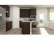 Modern kitchen with dark brown cabinets, granite countertops, and island at 612 Emerald Bay Cir, Raleigh, NC 27610