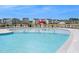 Community swimming pool with mushroom water feature and lounge chairs at 612 Emerald Bay Cir, Raleigh, NC 27610