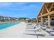 Resort-style pool with lounge chairs and covered seating area at 612 Emerald Bay Cir, Raleigh, NC 27610