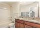 Bathroom with granite countertop, wood cabinets, and a shower/tub combo at 79 Stallion Way, Benson, NC 27504