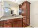 Bathroom with granite countertop, wood cabinets and a large mirror at 79 Stallion Way, Benson, NC 27504