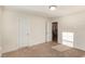 Versatile bedroom with neutral carpeting and access to the stairs at 79 Stallion Way, Benson, NC 27504