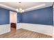 Formal dining room with blue walls, wainscoting, and hardwood floors at 79 Stallion Way, Benson, NC 27504