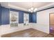 Elegant dining room with blue walls, wainscoting, and hardwood floors at 79 Stallion Way, Benson, NC 27504