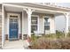 Inviting front porch with blue door and comfortable seating at 79 Stallion Way, Benson, NC 27504