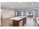 Modern kitchen with island, stainless steel appliances, and hardwood floors at 79 Stallion Way, Benson, NC 27504