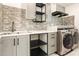 Laundry room with modern washer, dryer, and stylish gray cabinets at 79 Stallion Way, Benson, NC 27504