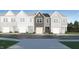 Two-story townhome with gray siding and a light-stone garage at 825 Windmill Palm Dr, Zebulon, NC 27597