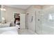 Spa-like bathroom with large shower, soaking tub, and a view into the bedroom at 921 Jasper Mine Trl, Raleigh, NC 27610