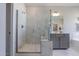 Elegant bathroom with walk-in shower, soaking tub, and gray vanity at 909 Jasper Mine Trl, Raleigh, NC 27610