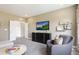 Spacious bonus room featuring a large TV, comfortable seating and built-in shelving at 909 Jasper Mine Trl, Raleigh, NC 27610