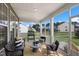 Peaceful screened porch with seating area and view of neighborhood at 909 Jasper Mine Trl # 740 Galvani, Raleigh, NC 27610