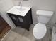 Updated bathroom with dark vanity and toilet at 1815 Bethlehem Rd, Rocky Mount, NC 27803