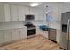 Newly renovated kitchen, featuring stainless steel appliances and white shaker cabinets at 1815 Bethlehem Rd, Rocky Mount, NC 27803