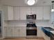 Modern kitchen with white cabinets, quartz countertops, and stainless steel appliances at 1815 Bethlehem Rd, Rocky Mount, NC 27803