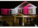 Two-story house with gray siding, stone accents, and a three-car garage at 2526 Snowdrop Ct, Apex, NC 27502