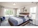 Bedroom with wood bed frame and plenty of natural light at 391 Fosterton Cottage Way, Raleigh, NC 27603