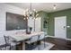 Modern dining room with light wood table and a statement light fixture at 391 Fosterton Cottage Way, Raleigh, NC 27603