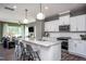Open concept kitchen with stainless steel appliances and an island with seating at 391 Fosterton Cottage Way, Raleigh, NC 27603