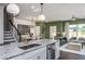 Open concept kitchen, island with seating, and view into living room at 391 Fosterton Cottage Way, Raleigh, NC 27603
