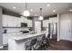 Modern kitchen with white cabinets, granite countertops, and a large island at 391 Fosterton Cottage Way, Raleigh, NC 27603