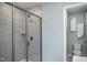 Clean bathroom with walk-in shower and gray tile at 393 Fosterton Cottage Way, Raleigh, NC 27603