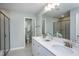 Modern bathroom with double vanity, large mirror, and walk-in shower at 393 Fosterton Cottage Way, Raleigh, NC 27603