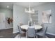 Elegant dining room with round table, gray chairs, and modern chandelier at 393 Fosterton Cottage Way, Raleigh, NC 27603