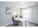 Bright home office with a large desk, two chairs, and natural light at 393 Fosterton Cottage Way, Raleigh, NC 27603