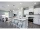 Open concept kitchen with island, stainless steel appliances, and breakfast bar at 393 Fosterton Cottage Way, Raleigh, NC 27603