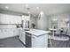 Modern kitchen with white cabinets, quartz countertops, and stainless steel appliances at 393 Fosterton Cottage Way, Raleigh, NC 27603