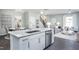 Open concept kitchen with island, stainless steel appliances, and breakfast bar at 393 Fosterton Cottage Way, Raleigh, NC 27603
