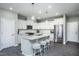 Modern kitchen with white cabinets, quartz countertops, and stainless steel appliances at 393 Fosterton Cottage Way, Raleigh, NC 27603