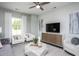 Living room with built-in media console, comfortable seating, and accent art at 393 Fosterton Cottage Way, Raleigh, NC 27603