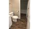 Small bathroom with white toilet and vanity, wood-look floors at 4600 Millstone Dr # D, Raleigh, NC 27604